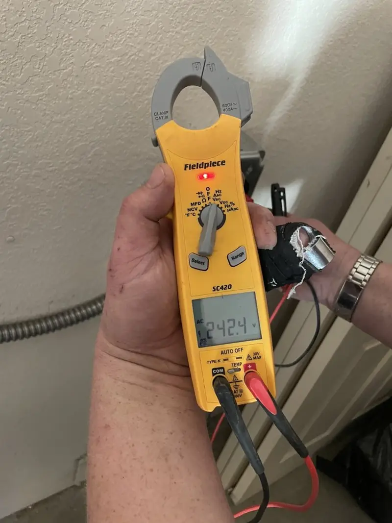 Voltage testing with clamp meter during Whole House Surge Protector in Taylor